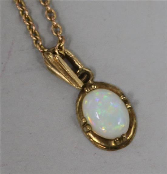 A 9ct gold and white opal oval pendant on a 9ct gold chain, chain pendant 11mm.